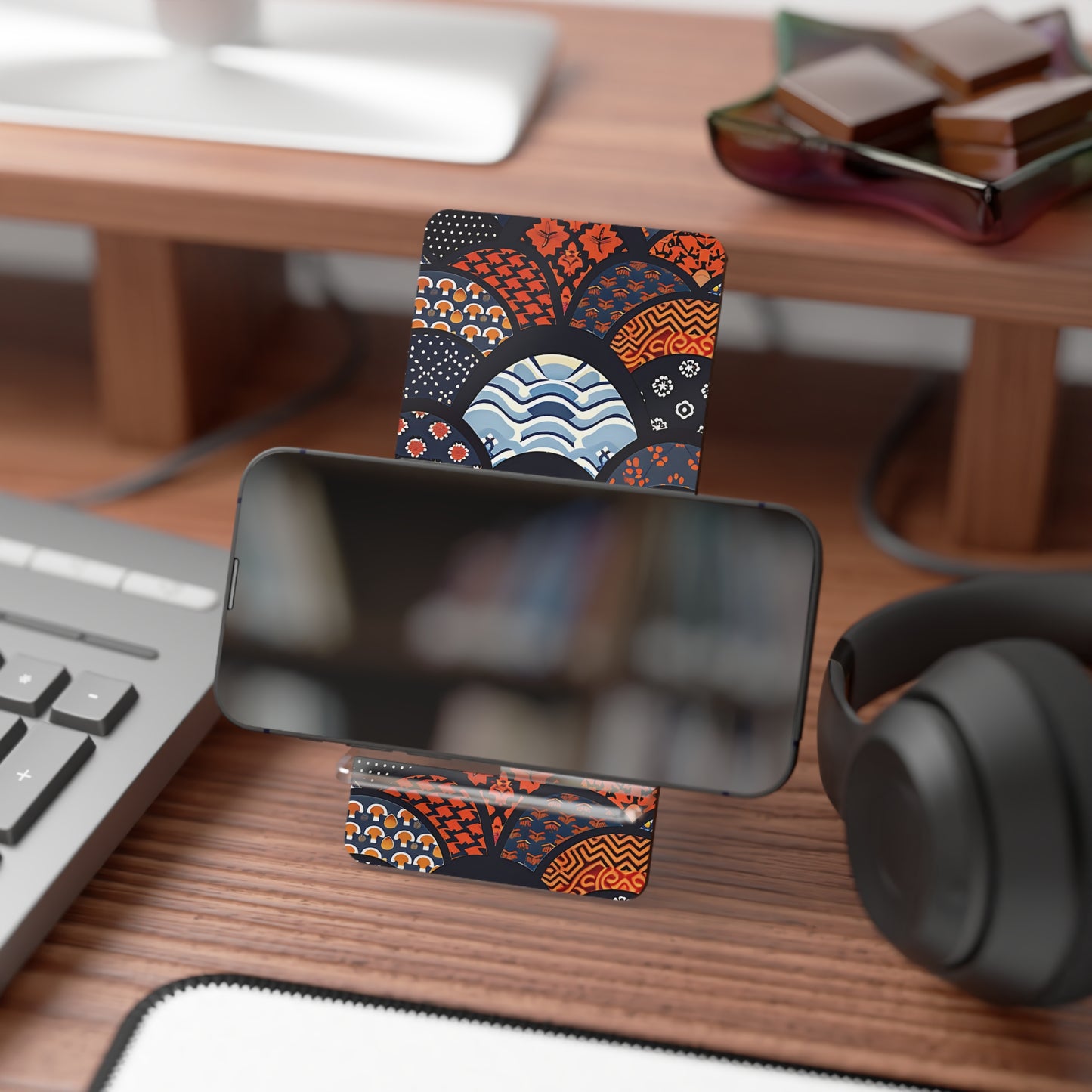 Phone stand with decorative card on a desk with keyboard, mouse, and headphones. | Casenari