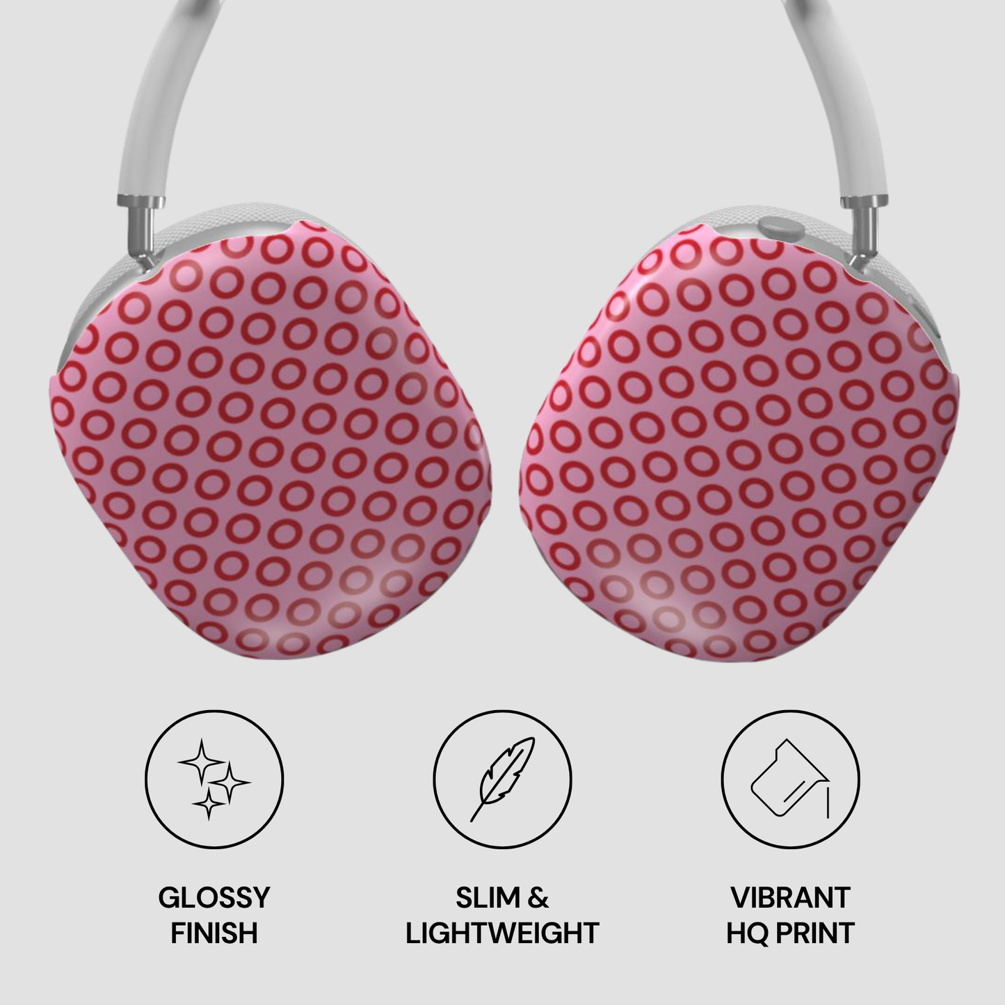 Pink polka dot earrings with glossy finish, slim design, and vibrant print on a light gray background.