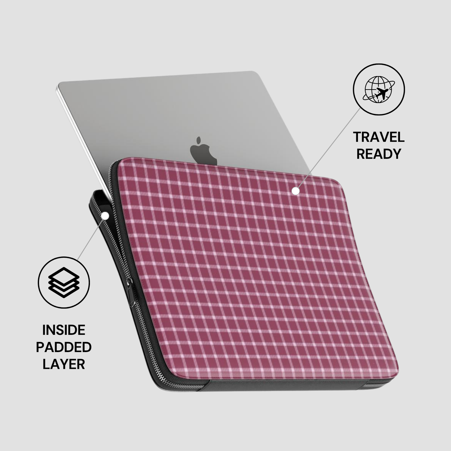 Pink checkered laptop sleeve with gray laptop on a light gray background