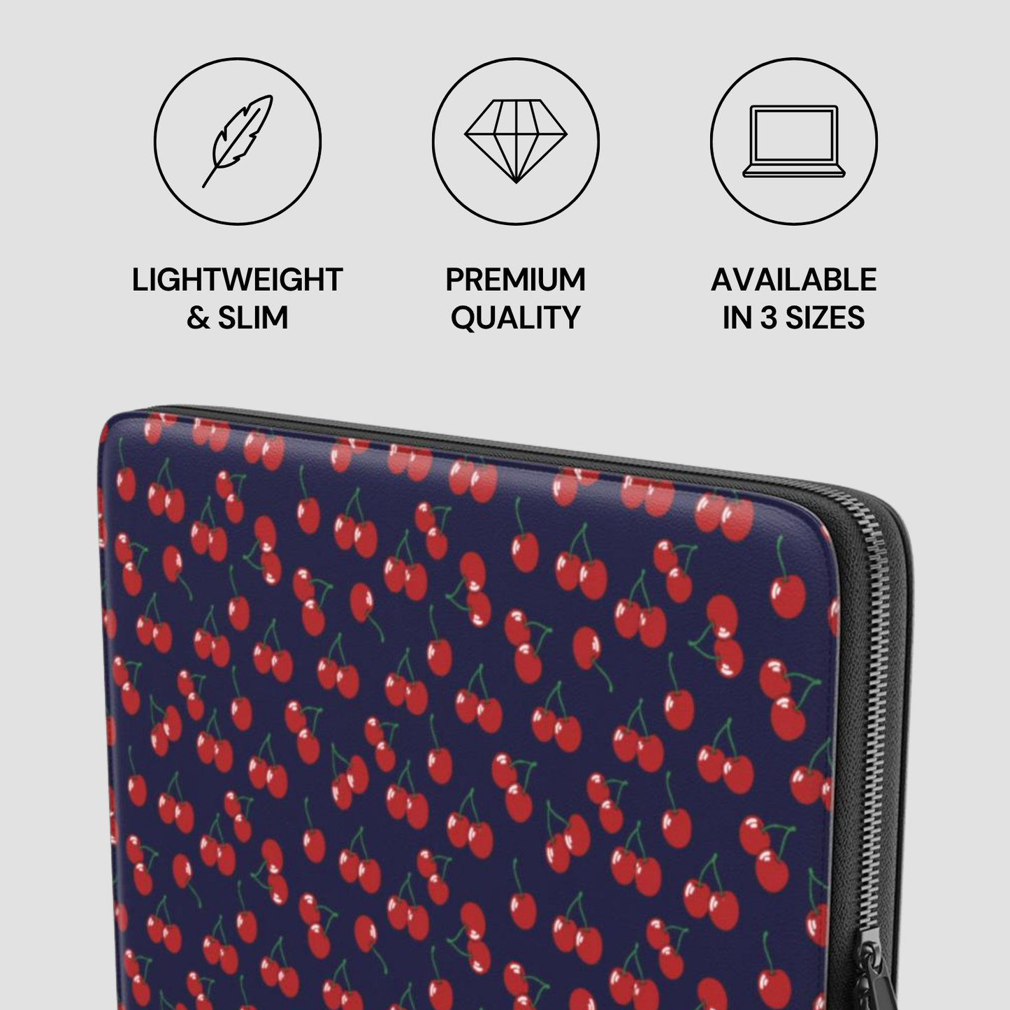 Laptop sleeve with cherry pattern and product features on a light gray background