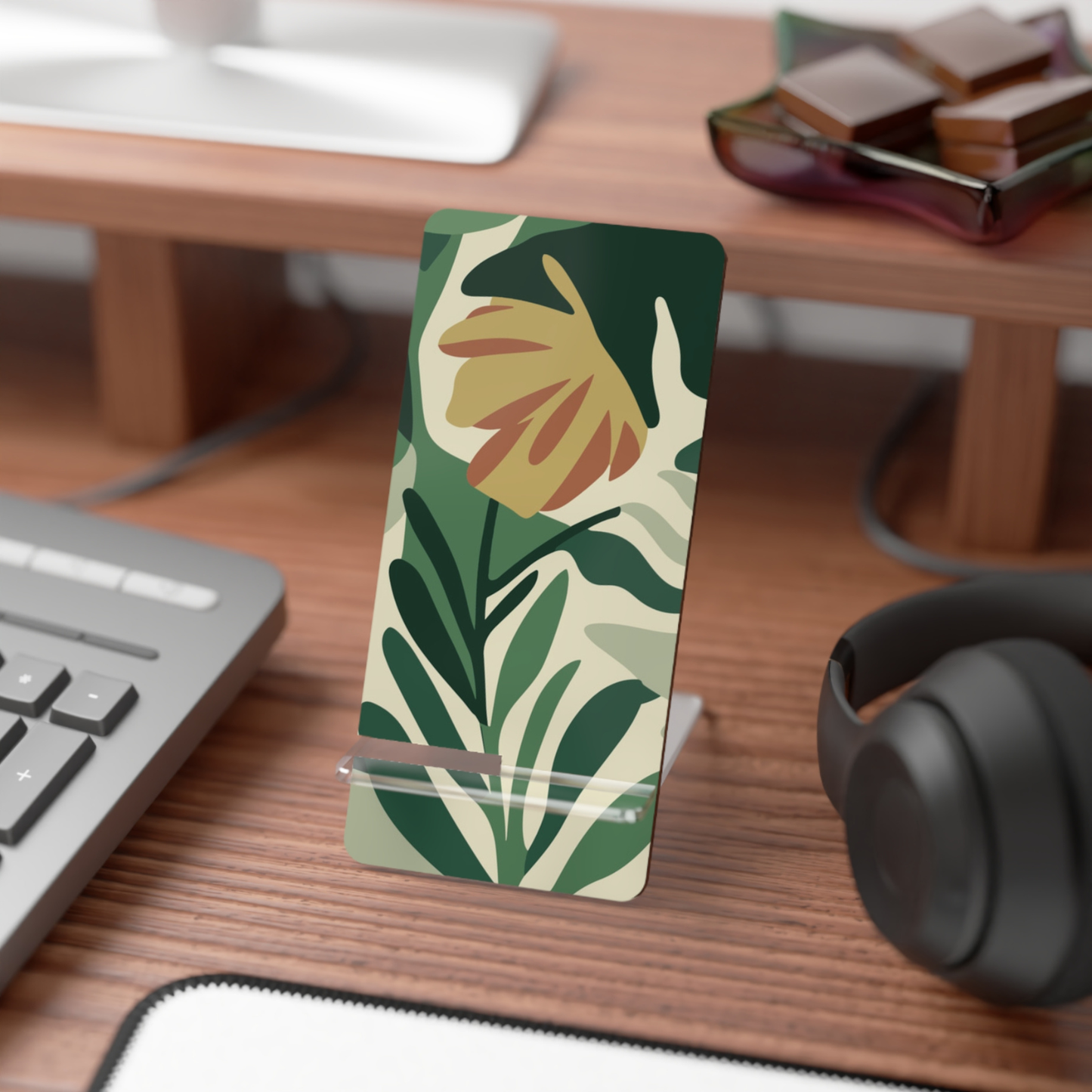 Floral phone stand on a desk with keyboard, mouse, and headphones