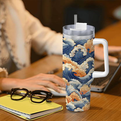 Tumbler with wave design on a desk with a person using a laptop.