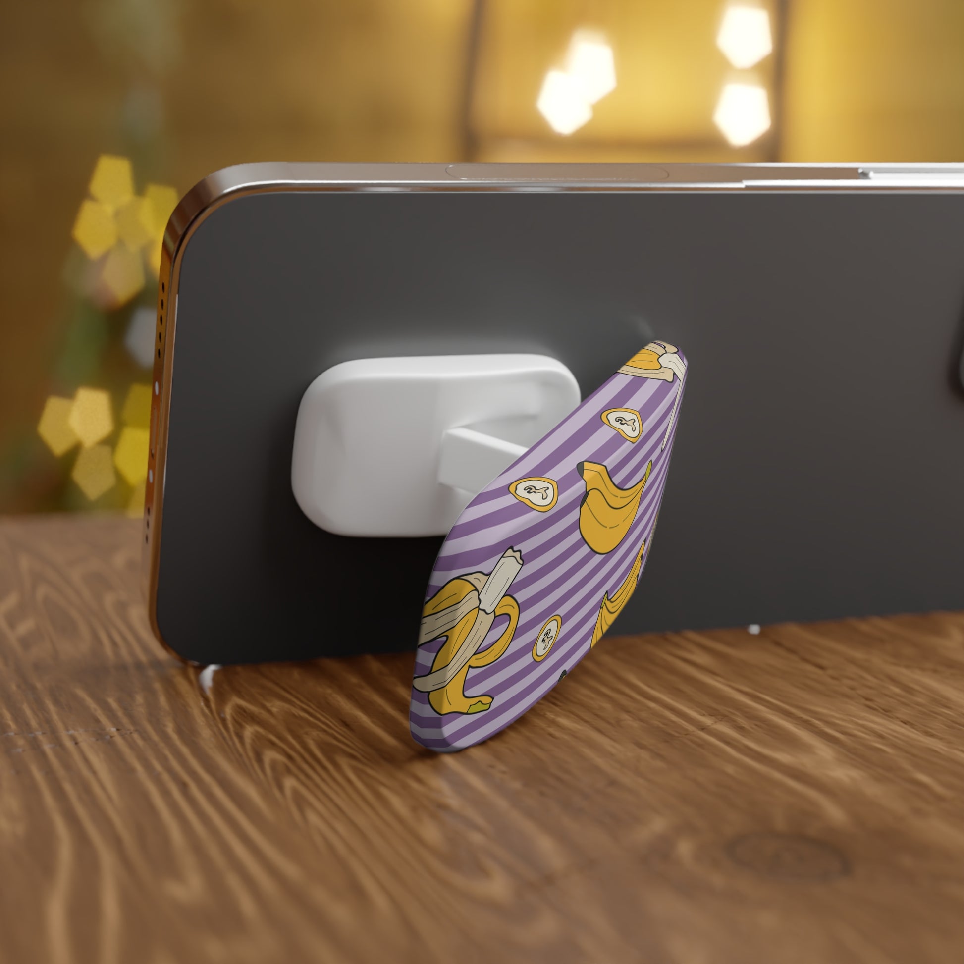 Phone grip with banana design on a wooden surface
