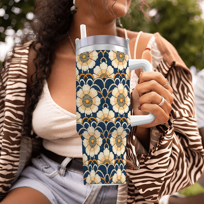 Person holding a floral-patterned tumbler with a blurred background