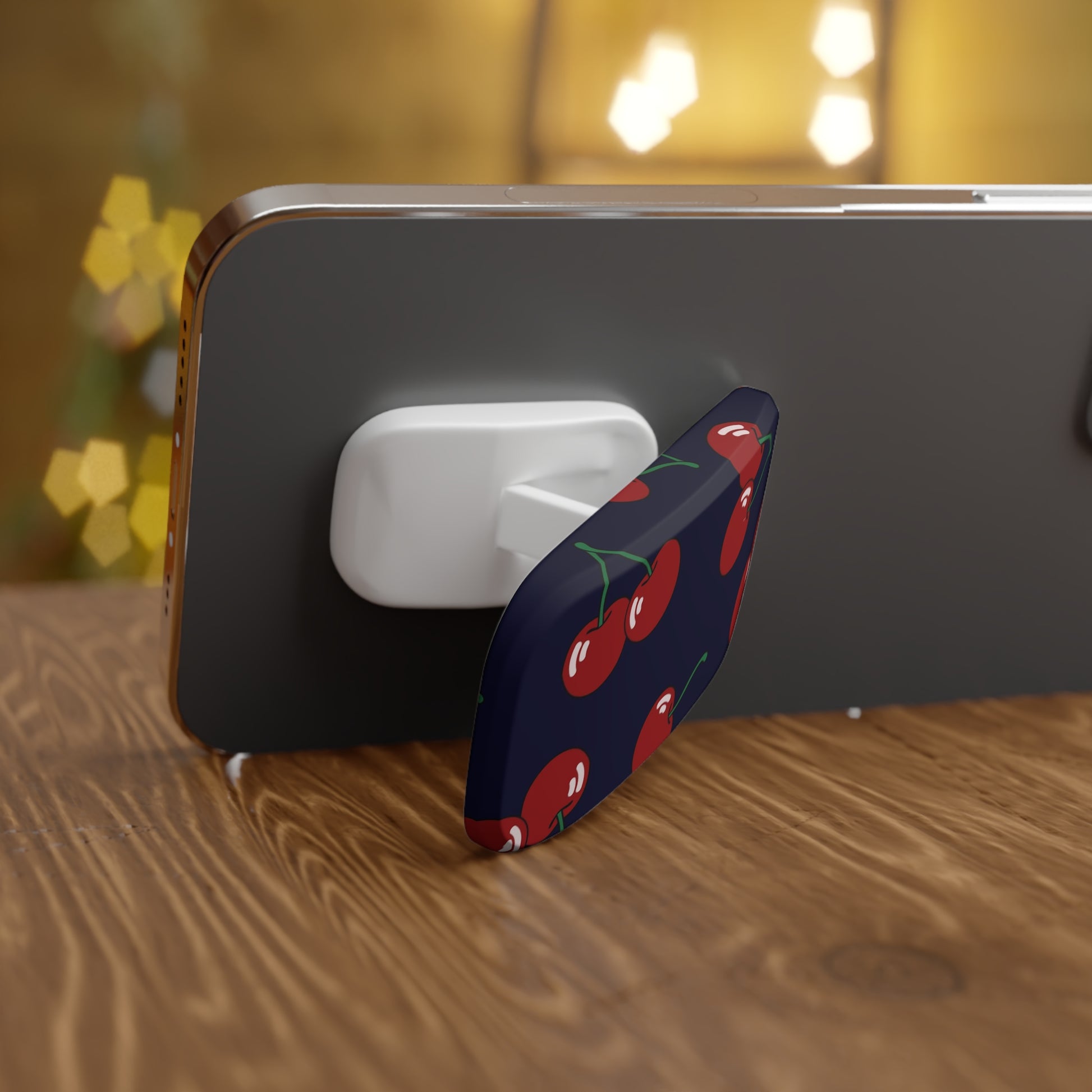 Phone case with cherry design on a wooden surface