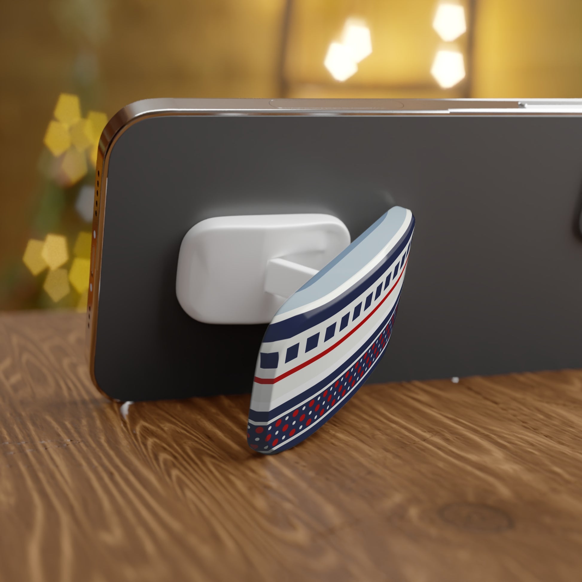 Phone with a decorative boat-shaped phone stand on a wooden surface