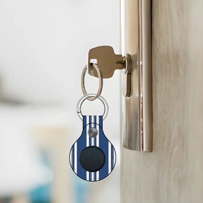 Keychain with a blue and white striped design attached to a door handle.