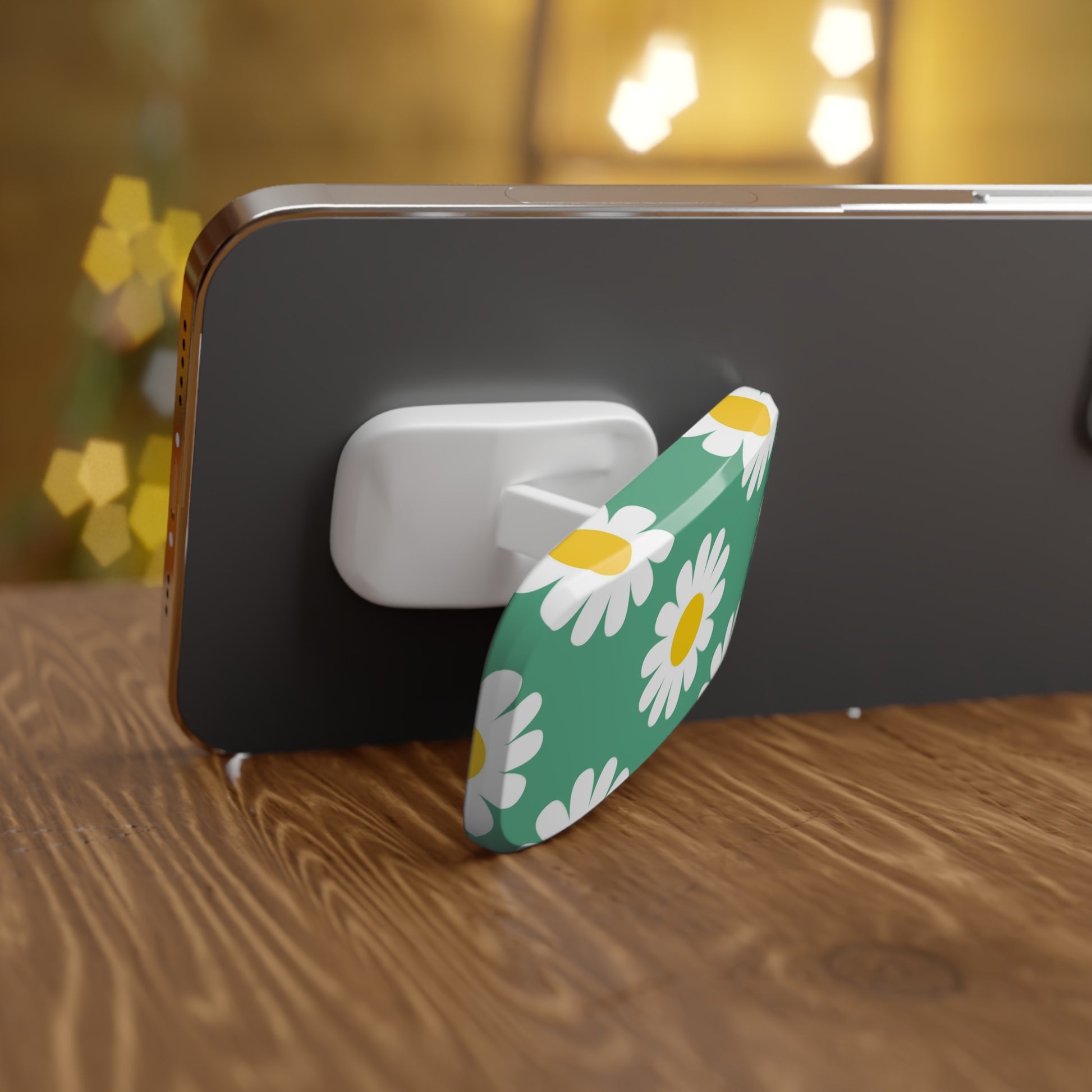 Phone with a floral design stand on a wooden surface with blurred lights in the background