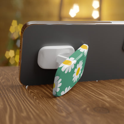 Phone with a floral design stand on a wooden surface with blurred lights in the background