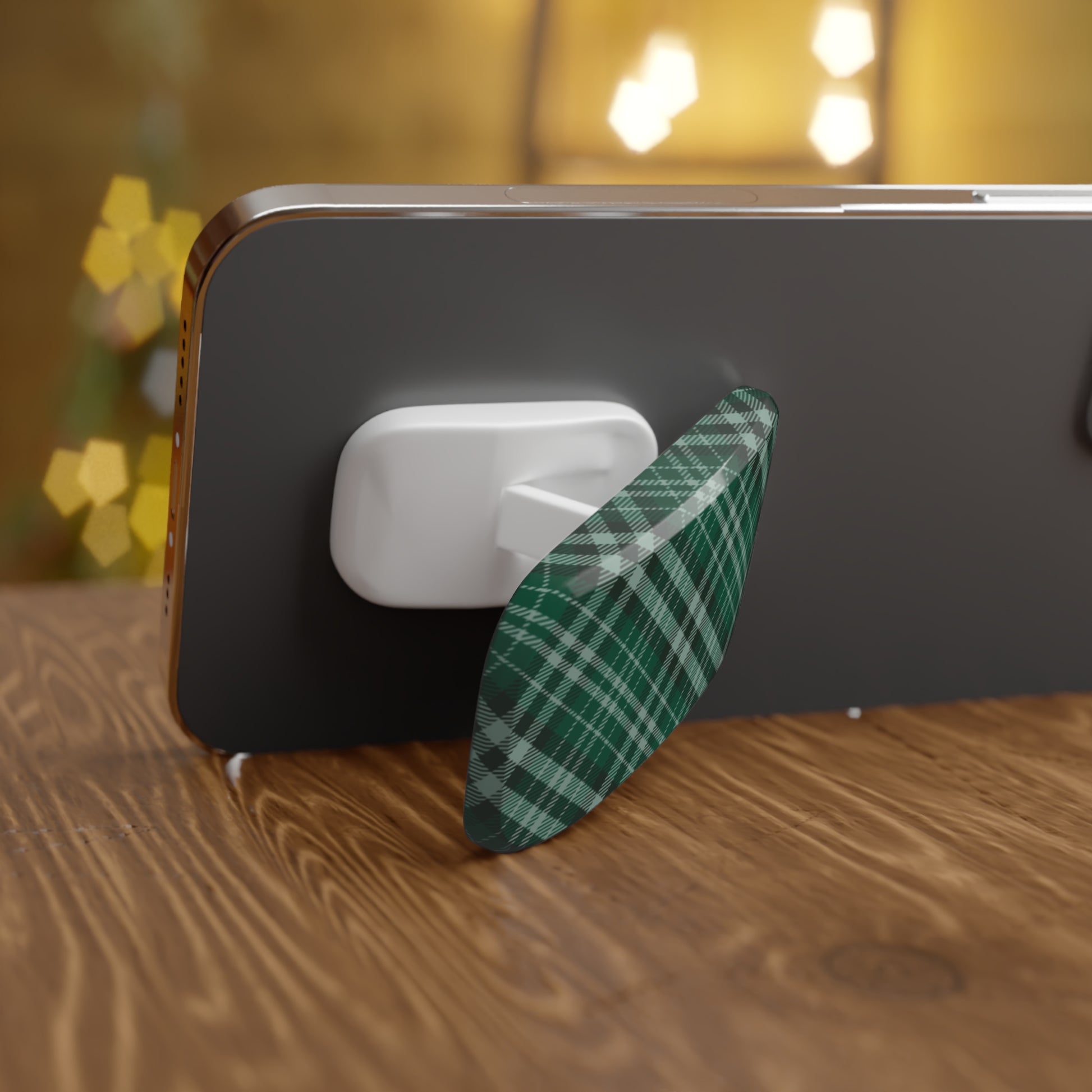 Phone with a green plaid case on a wooden surface with blurred lights in the background | Casenari