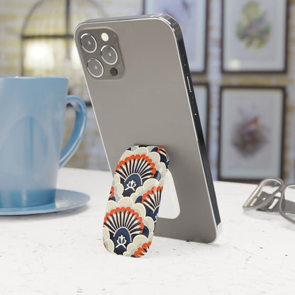 Phone stand with decorative design on a table next to a blue mug