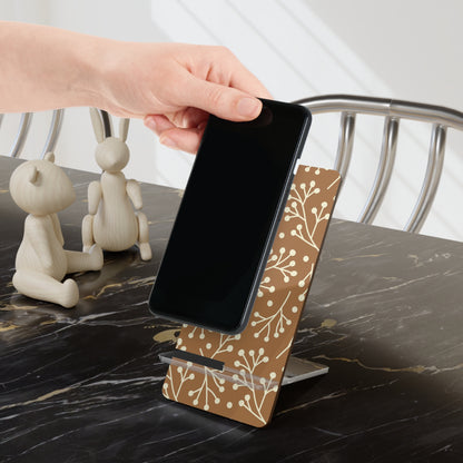 Person placing a phone on a wooden stand with floral pattern on a marble surface.