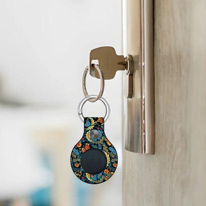 Keychain with a floral design attached to a door handle.