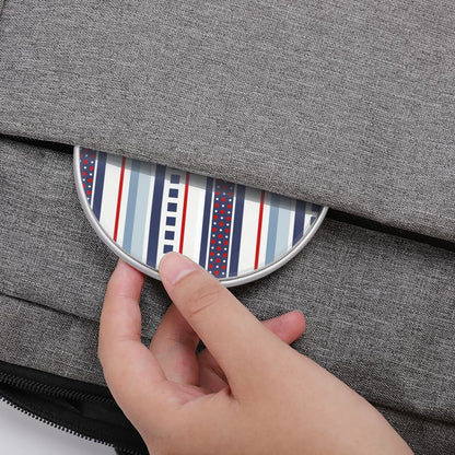 Hand placing a striped coaster into a gray fabric bag
