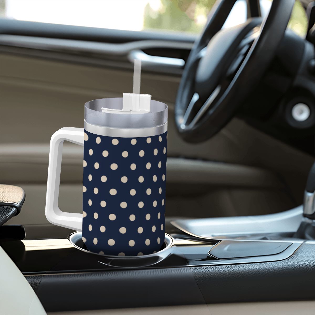 Navy blue mug with white polka dots on a car dashboard