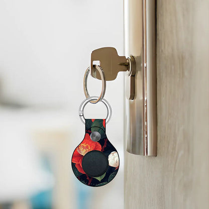 Keychain with a floral design attached to a door handle.