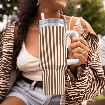 Person holding a striped mug with a blurred background