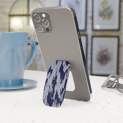 Phone with a blue and white patterned stand on a table next to a blue mug.