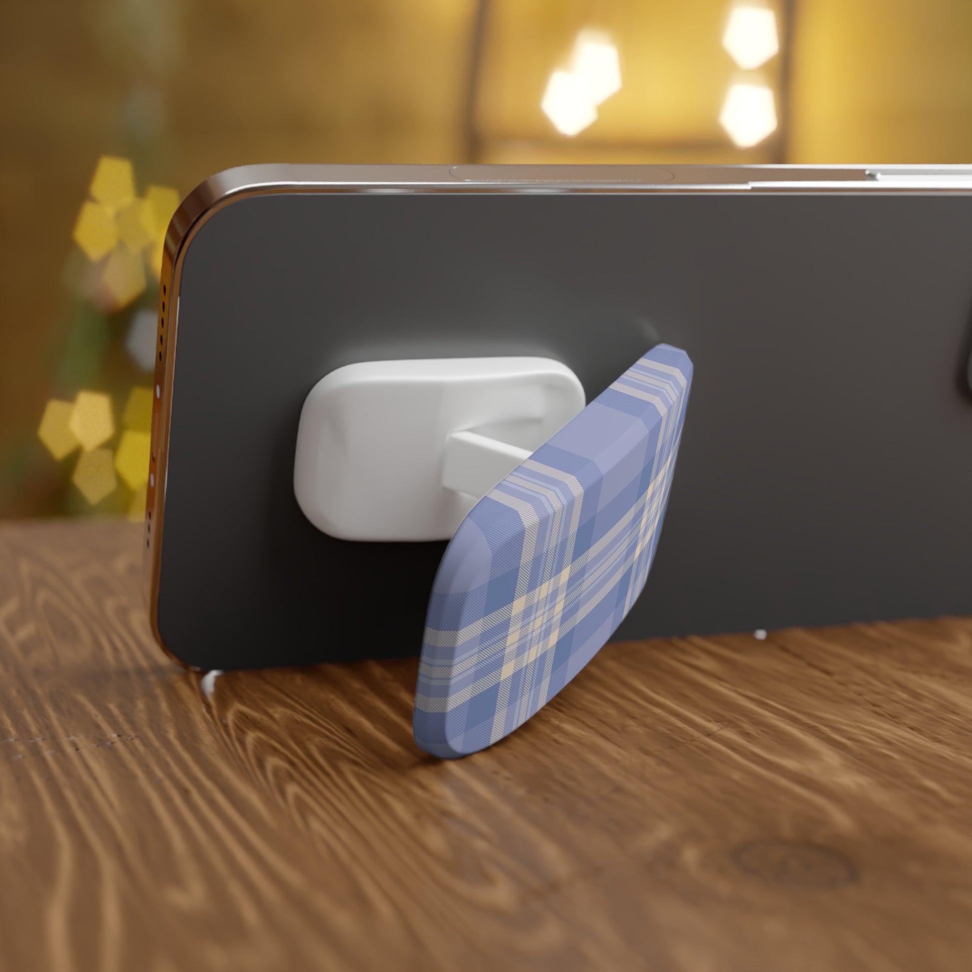 Phone with a blue and white checkered stand on a wooden surface