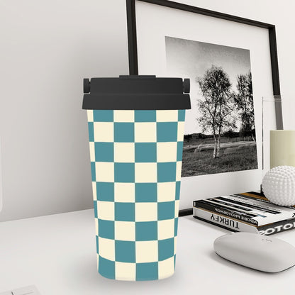 Checkered patterned tumbler on a desk with a framed picture in the background