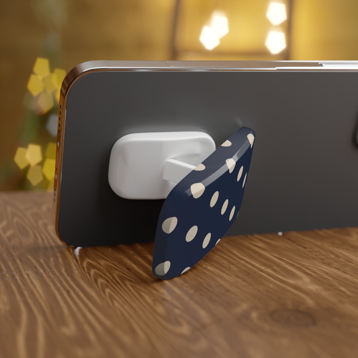 Phone holder with polka dot design on a wooden surface