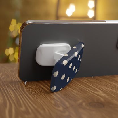 Phone holder with polka dot design on a wooden surface