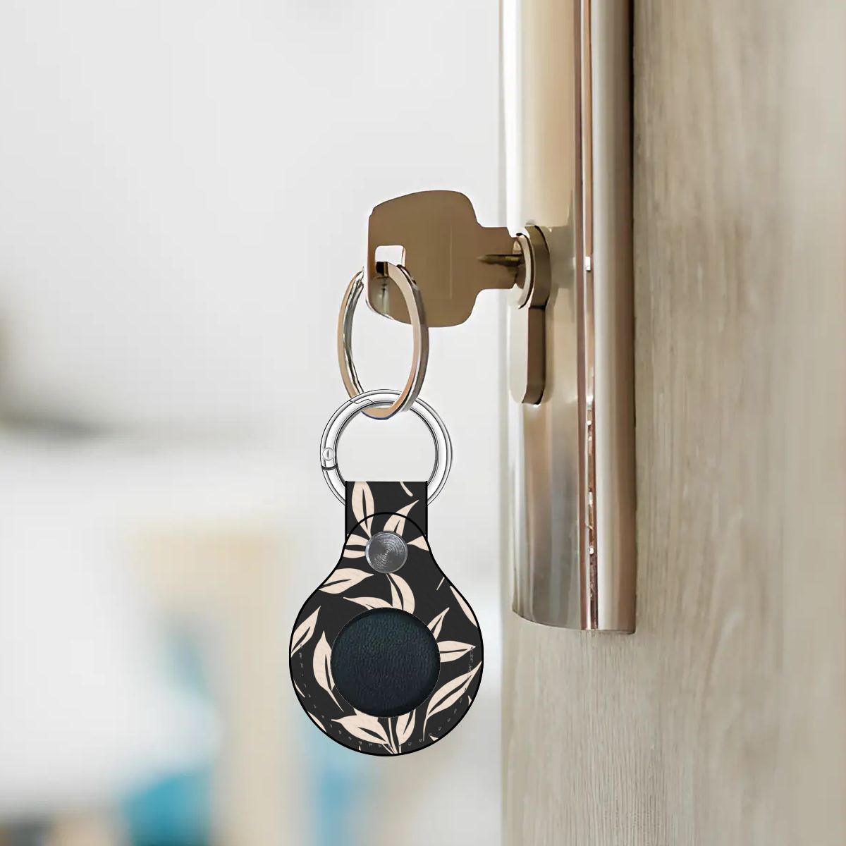 Keychain with a black and white pattern attached to a door handle.