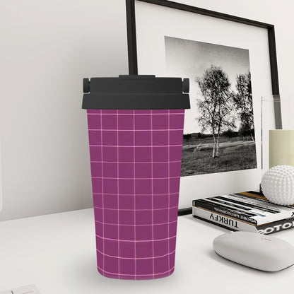 Plaid-patterned tumbler on a desk with a framed picture in the background