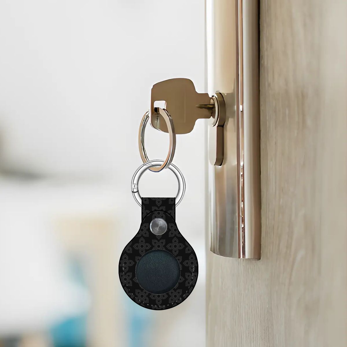 Keychain with a black device attached to a door handle.