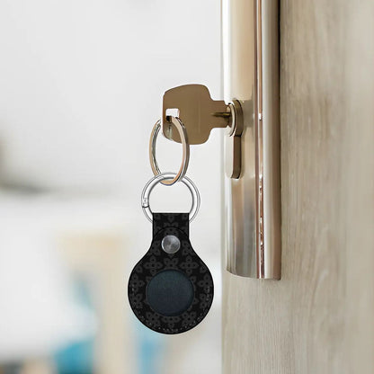 Keychain with a black device attached to a door handle.