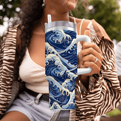 Person holding a tumbler with wave design outdoors