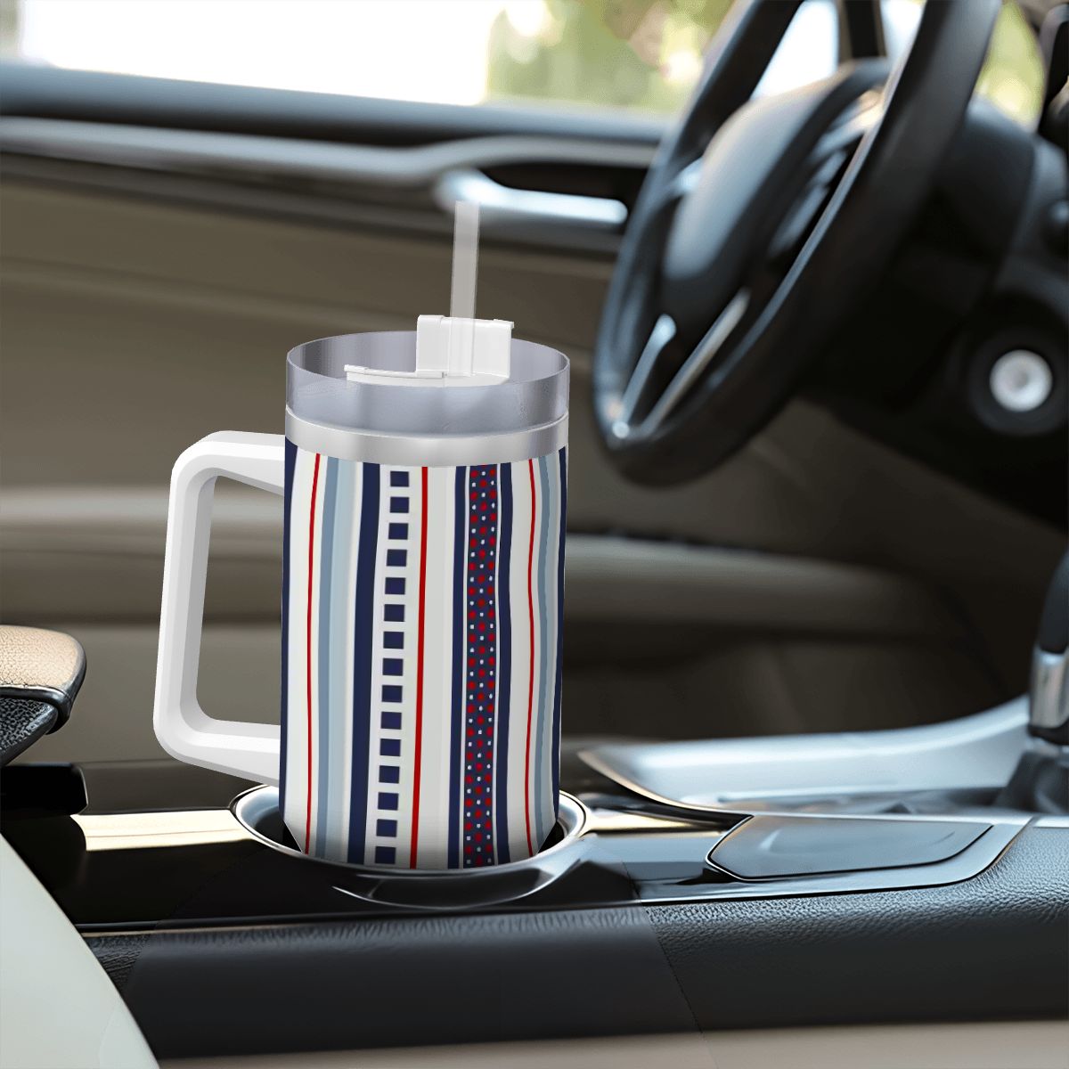 Striped mug with a straw on a car cup holder