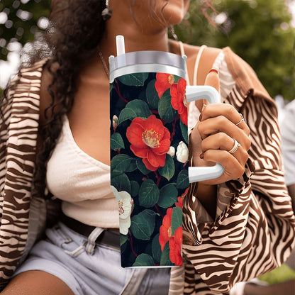 Person holding a floral-patterned tumbler outdoors