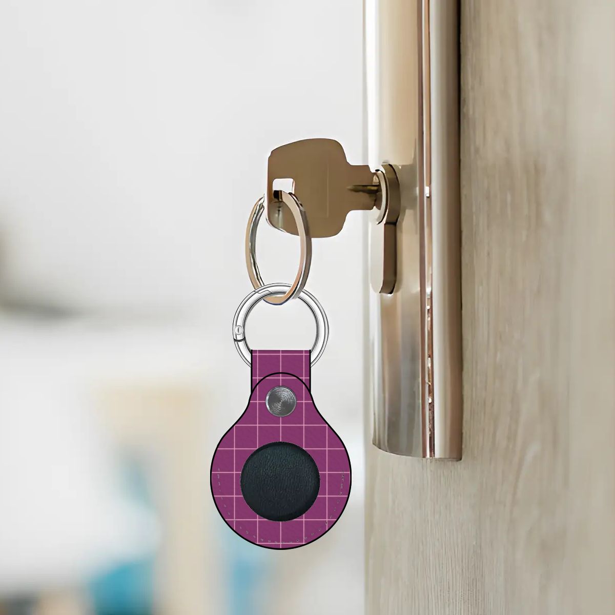 Purple keychain device attached to a door handle