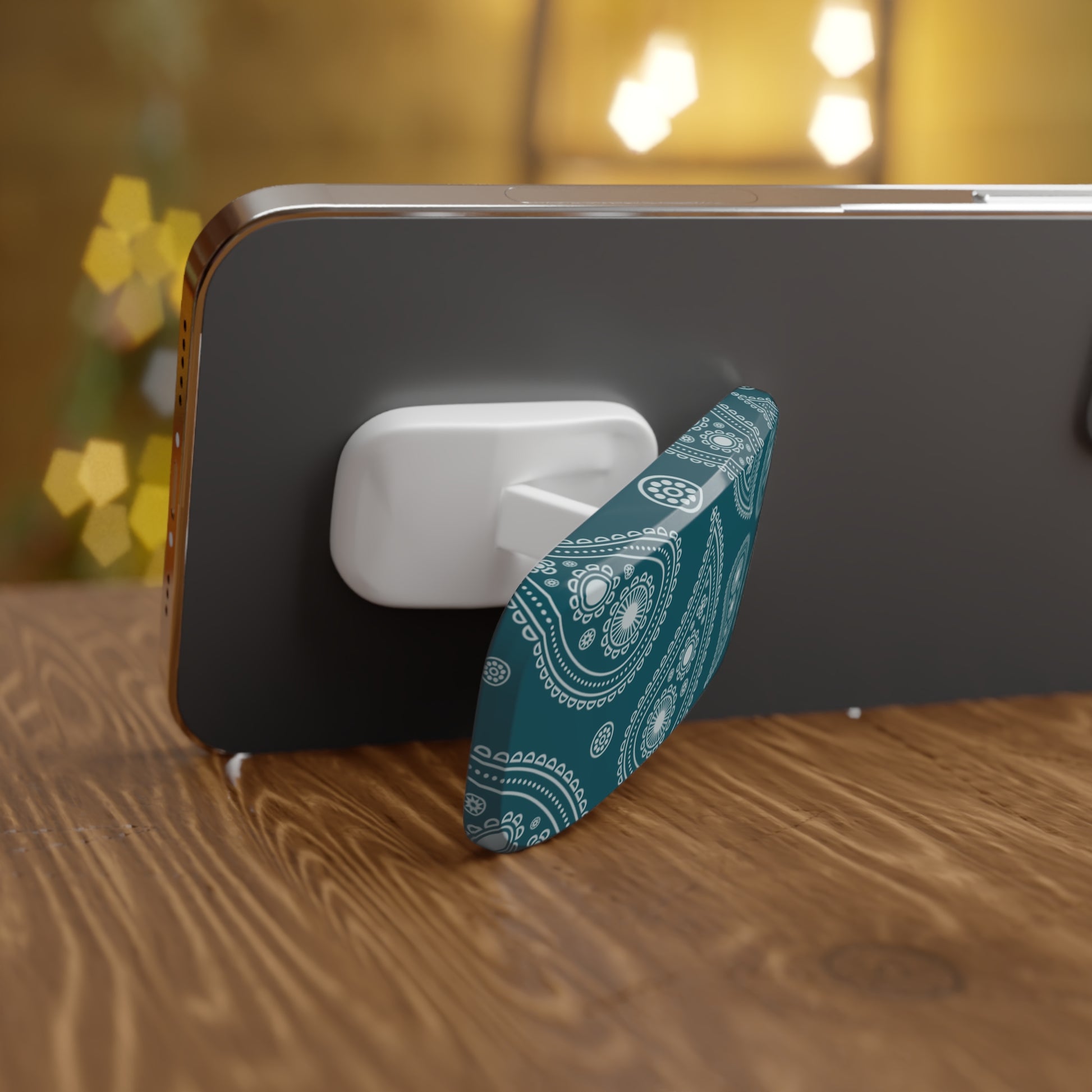 Phone with a blue and white patterned stand on a wooden surface