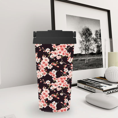 Tumbler with floral design on a desk next to a framed picture