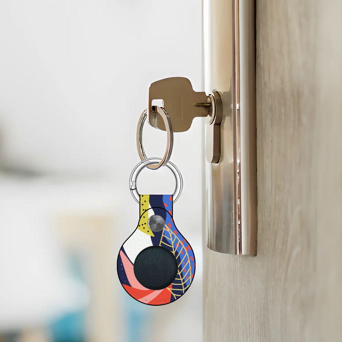 Colorful keychain attached to a doorknob with a blurred background