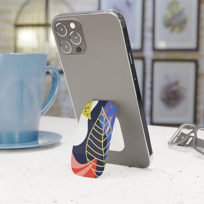 Phone case with colorful design on a desk next to a blue mug