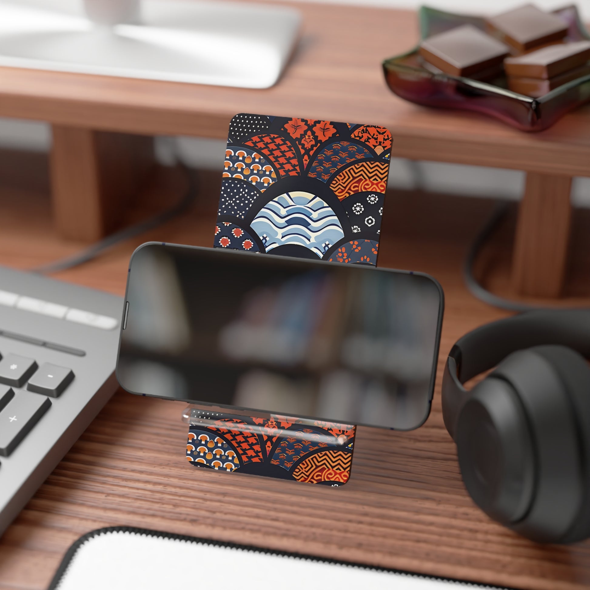Phone stand with decorative card on a desk with keyboard, mouse, and headphones. | Casenari