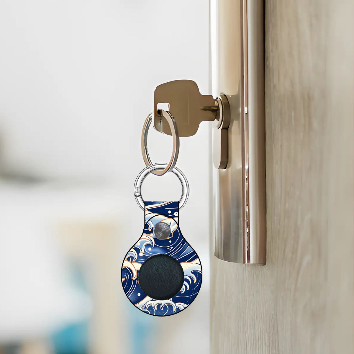 Keychain with a blue and white design attached to a door handle. | Casenari