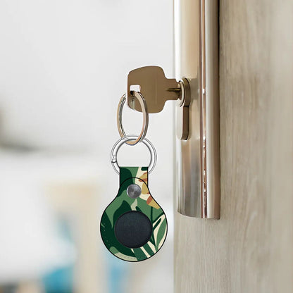 Keychain with a green leaf pattern attached to a door handle.