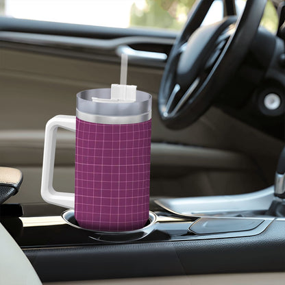 Purple grid-patterned mug with a straw on a car cup holder