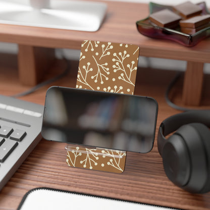 Business card holder with floral design on a desk with computer and headphones