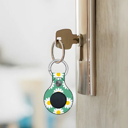 Keychain with a floral design attached to a door handle.