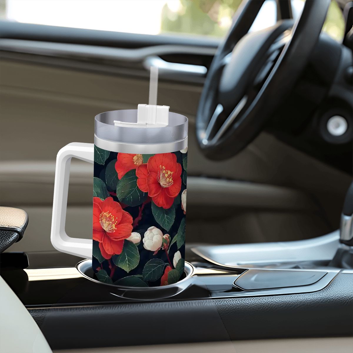 Floral-patterned mug with a straw on a car dashboard