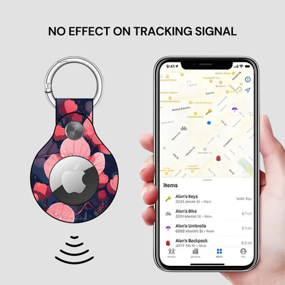 Floral-patterned keychain device with Apple logo next to a smartphone displaying a location app.
