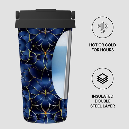 Insulated tumbler with blue floral pattern and black lid on a light gray background