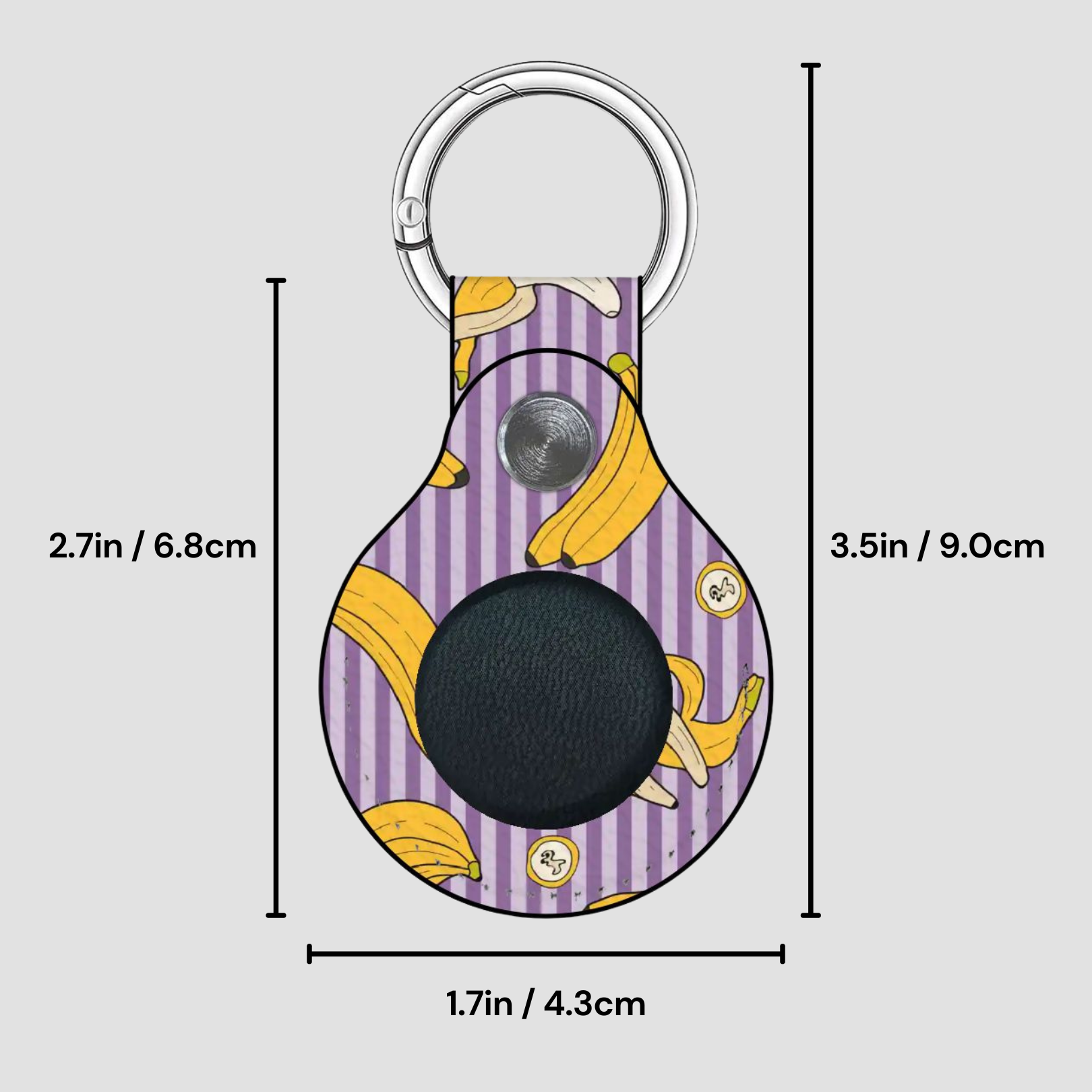 Keychain with banana design and measurements on a gray background