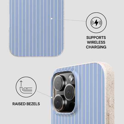 Phone case with blue and white striped pattern, showing raised bezels and wireless charging support on a light gray background.