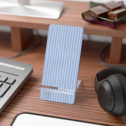 Phone stand with green leaf pattern on a desk with keyboard and headphones